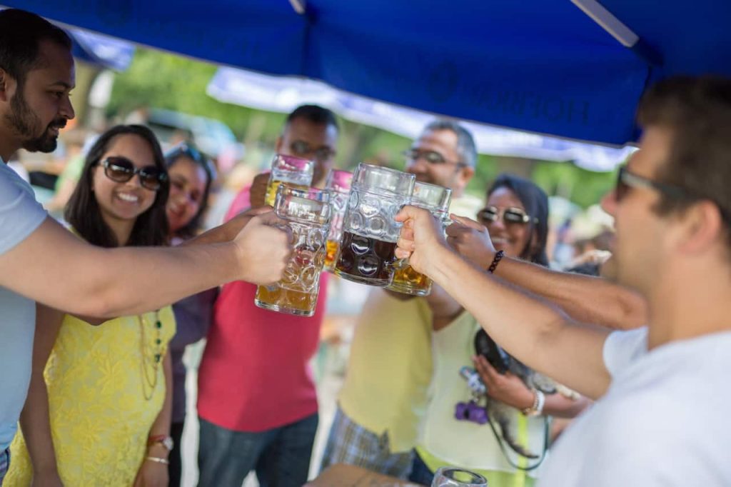 Group holding beer steins