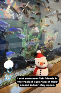 Snowman in front of fish tank